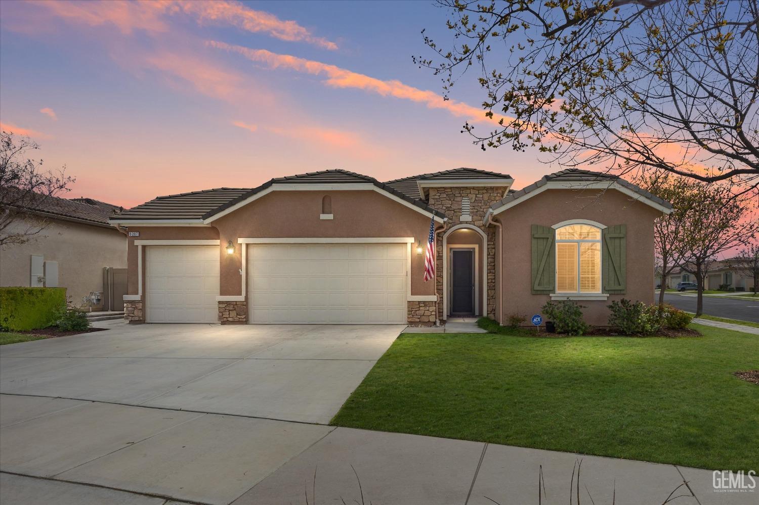 Undisclosed Address Bakersfield, CA 93306 - Photo 1 of 70 a front view of a house with a yard and garage