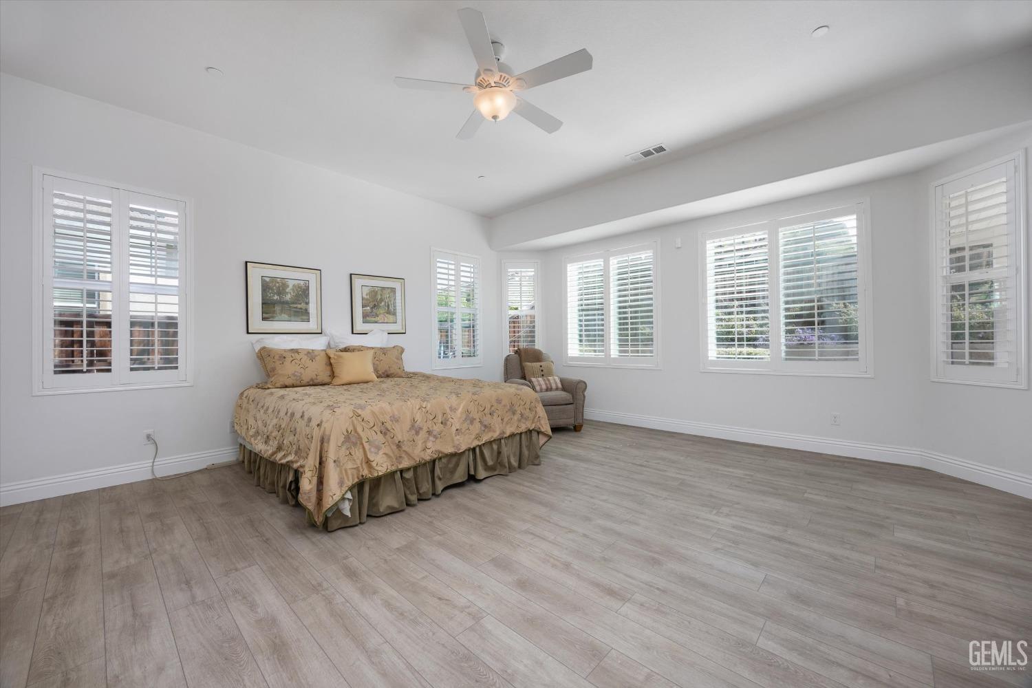 Undisclosed Address Bakersfield, CA 93306 - Photo 17 of 70 a bedroom with a large bed chandelier and a window