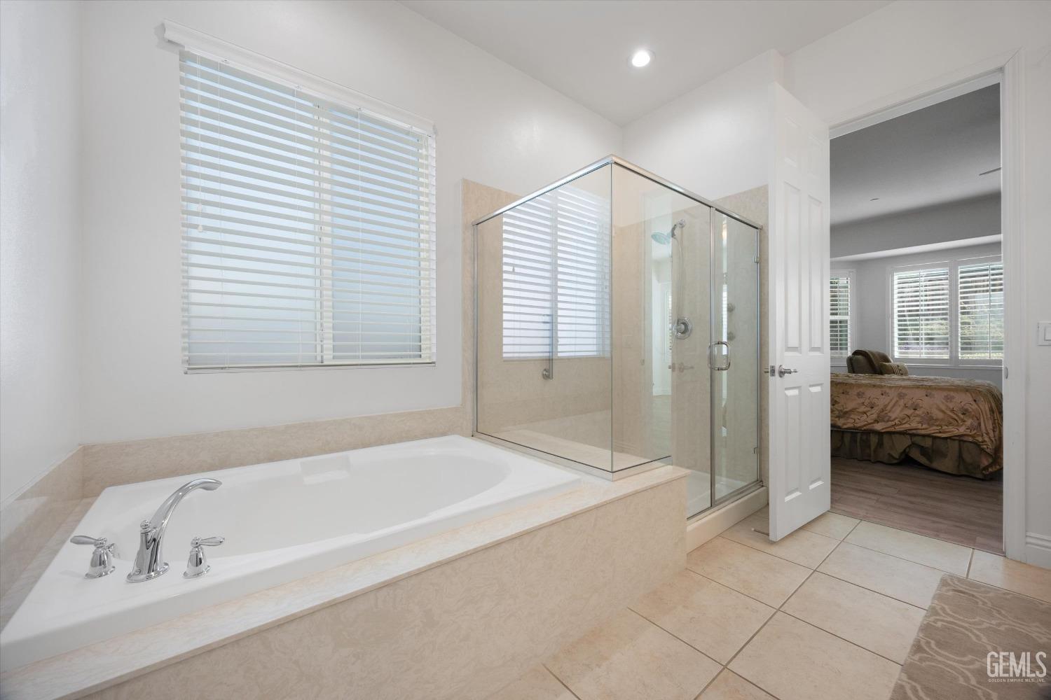 Undisclosed Address Bakersfield, CA 93306 - Photo 21 of 70 a spacious bathroom with a bathtub and a shower