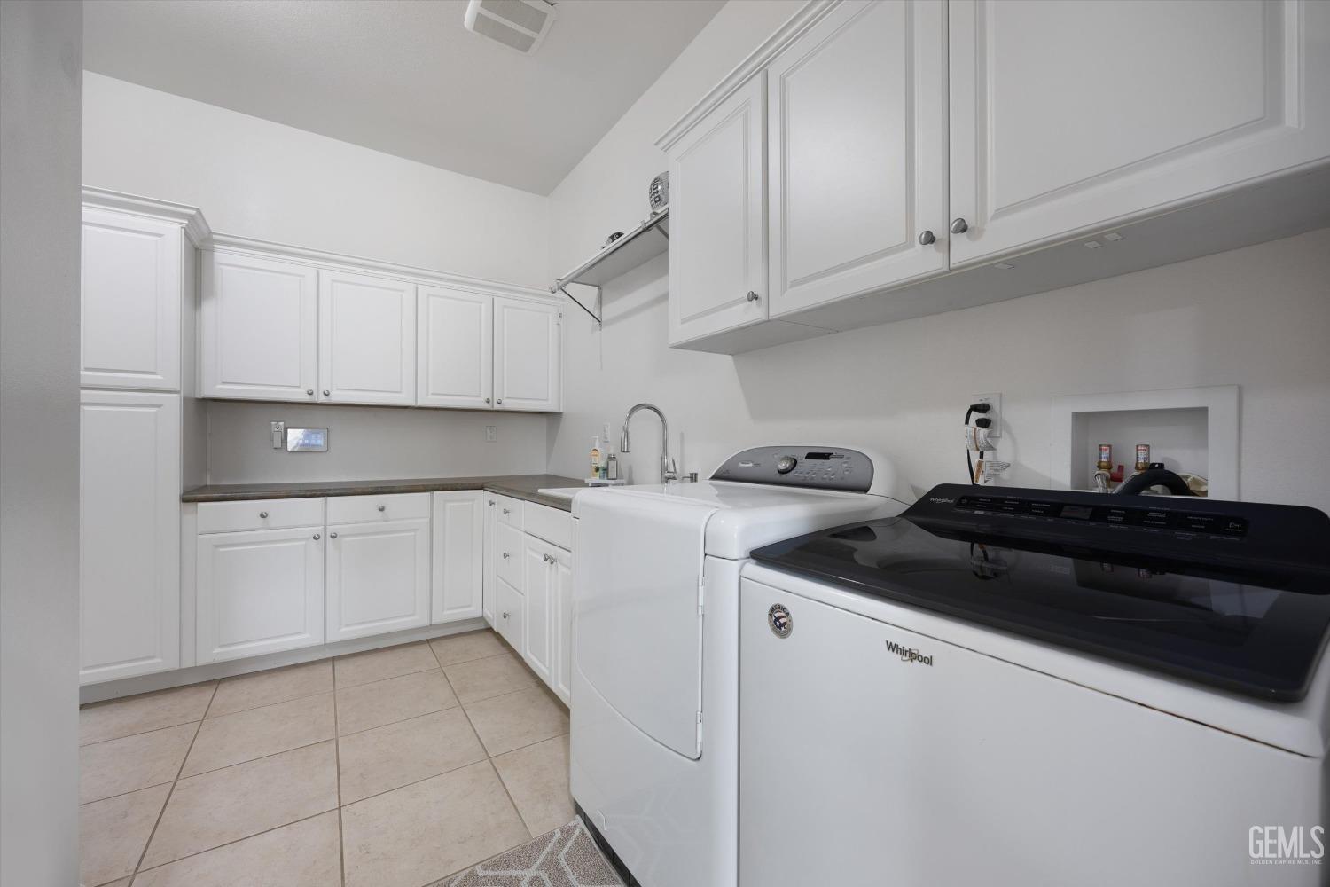 Undisclosed Address Bakersfield, CA 93306 - Photo 27 of 70 a kitchen with cabinets appliances a sink and a counter top