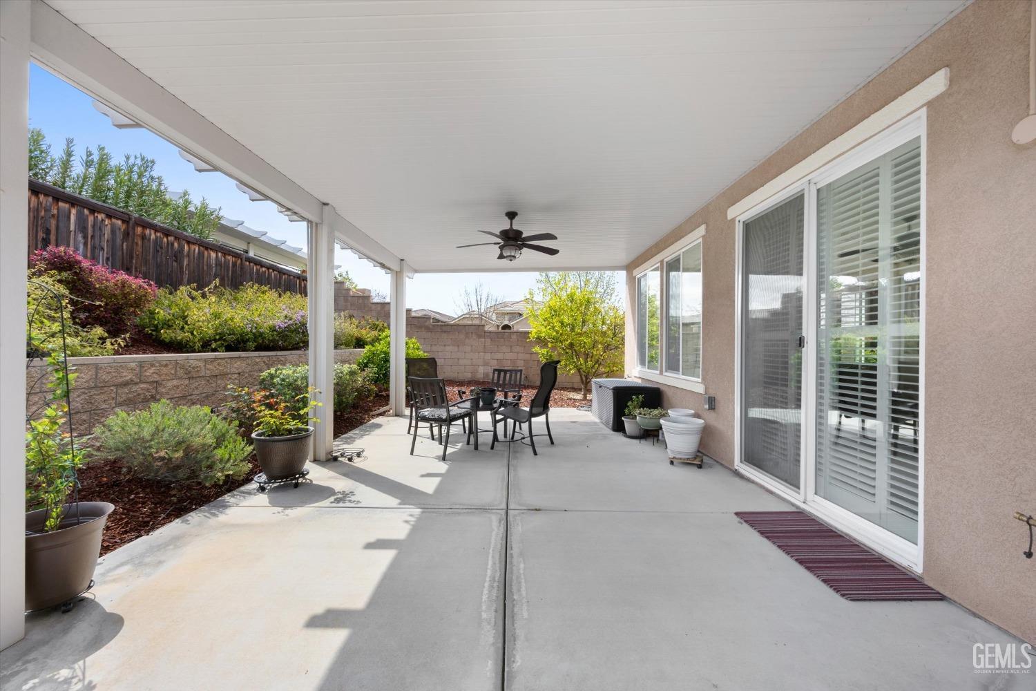 Undisclosed Address Bakersfield, CA 93306 - Photo 30 of 70 a view of a patio with table and chairs potted plants and floor to ceiling window