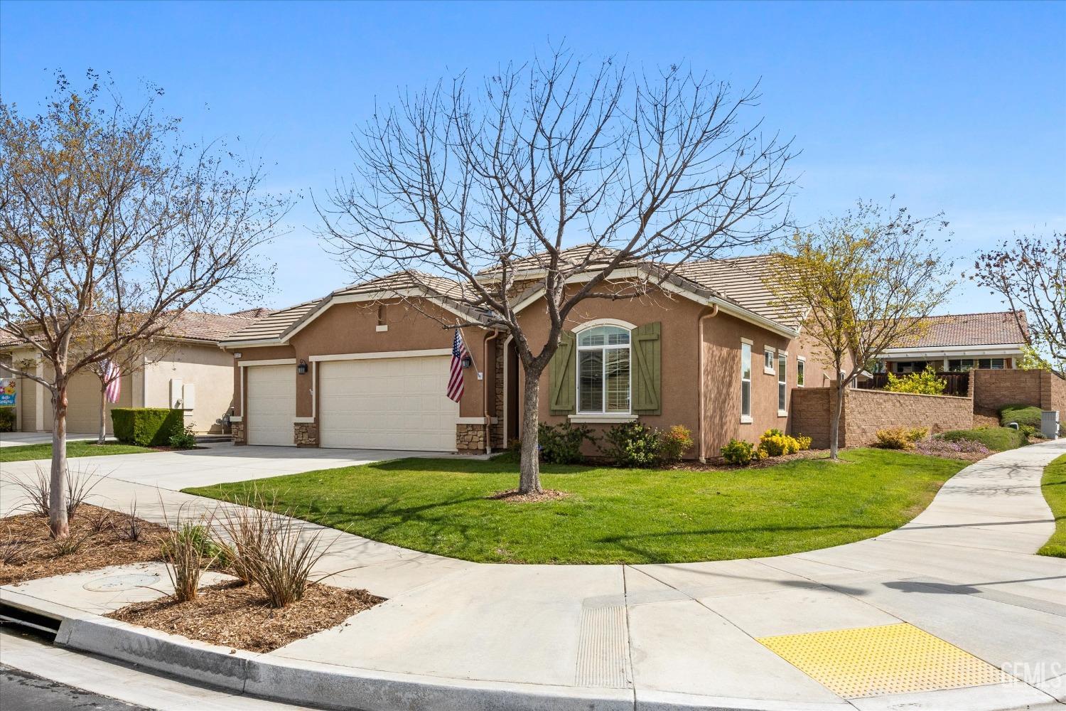Undisclosed Address Bakersfield, CA 93306 - Photo 40 of 70 a front view of a house with a yard and garage