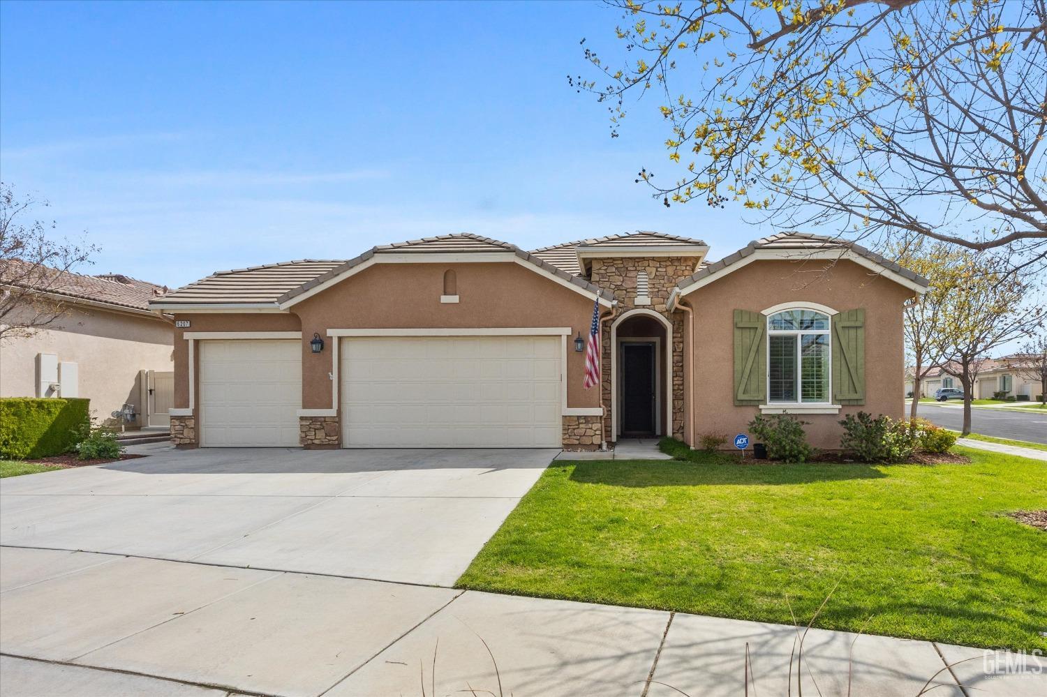 Undisclosed Address Bakersfield, CA 93306 - Photo 41 of 70 a front view of a house with a garden
