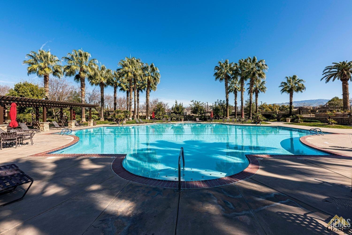Undisclosed Address Bakersfield, CA 93306 - Photo 55 of 70 a view of a lake with a swimming pool and a yard