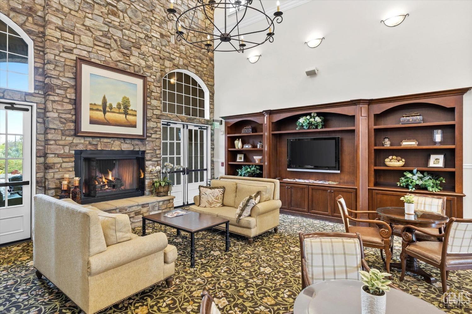 Undisclosed Address Bakersfield, CA 93306 - Photo 65 of 70 a living room with furniture a flat screen tv and a fireplace