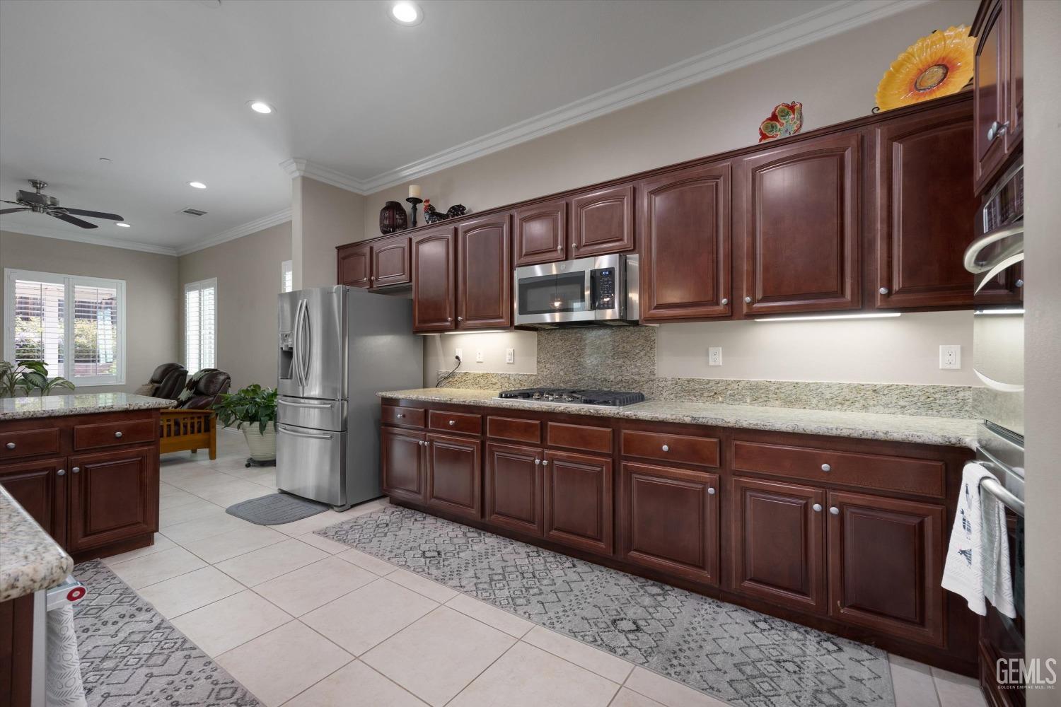Undisclosed Address Bakersfield, CA 93306 - Photo 10 of 70 a kitchen with stainless steel appliances granite countertop a sink and cabinets