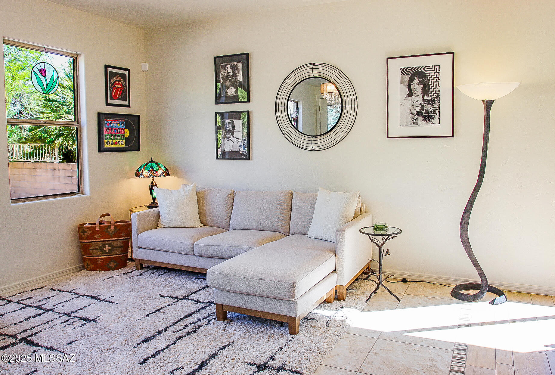 5202 Spring View Drive Tucson, AZ 85749 - Photo 16 of 49 a living room with furniture a wall clock and a potted plant