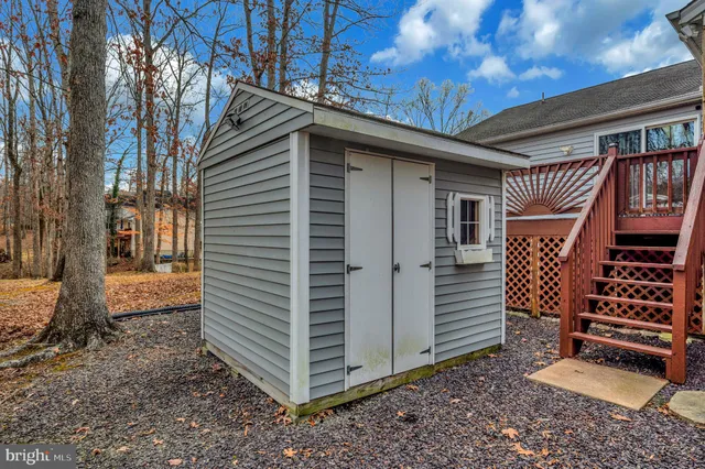 a living room with furniture and a ceiling fan