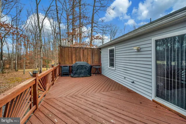 a living room with furniture ceiling fan and a window