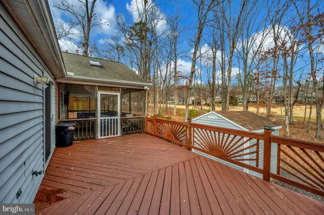 a living room with furniture a chandelier and a flat screen tv