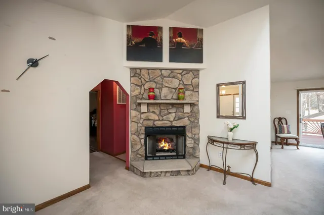 a dining room with furniture a chandelier and window