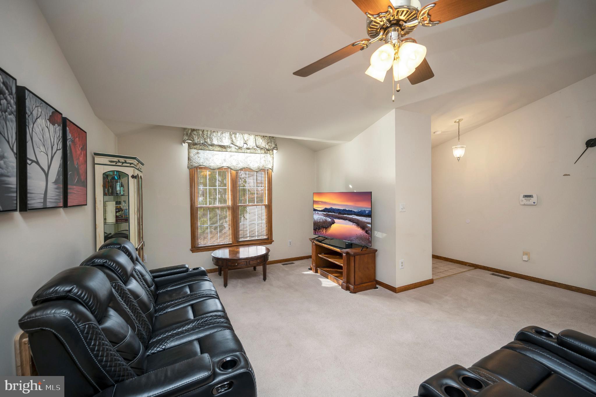 117 Green Street Locust Grove, VA 22508 - Photo 20 of 63 a living room with furniture a chandelier and a flat screen tv