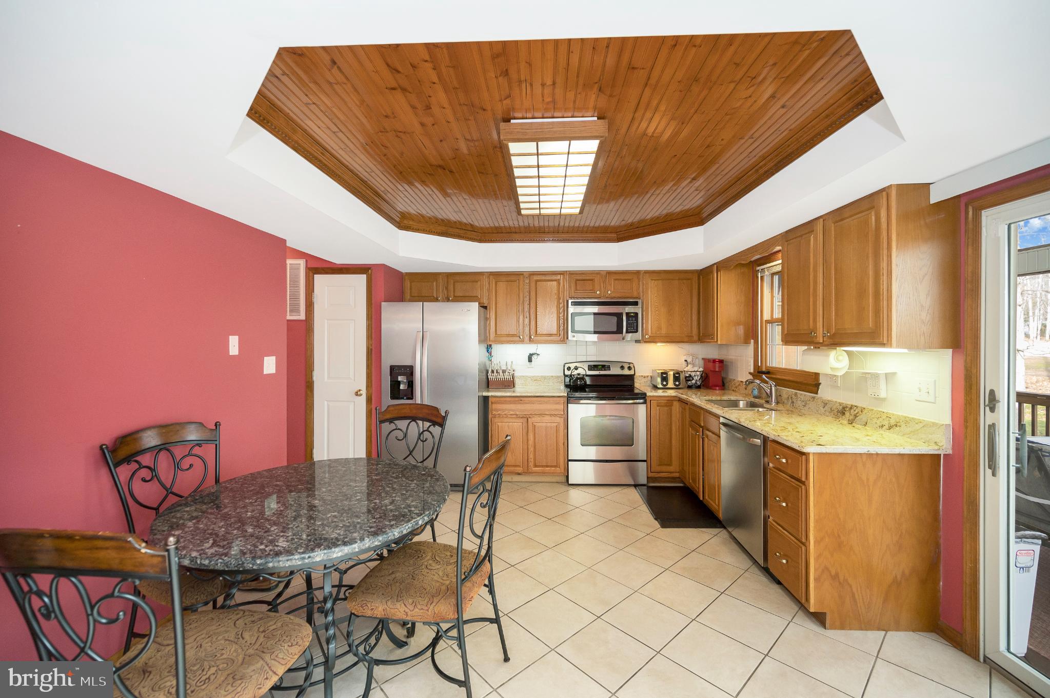 117 Green Street Locust Grove, VA 22508 - Photo 27 of 63 a kitchen with stainless steel appliances granite countertop a sink dishwasher and a refrigerator