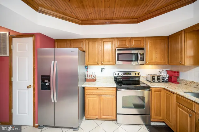a bed sitting in a bedroom next to a window with a dresser