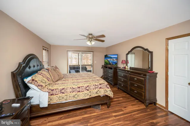 a bedroom with a bed dresser and a window