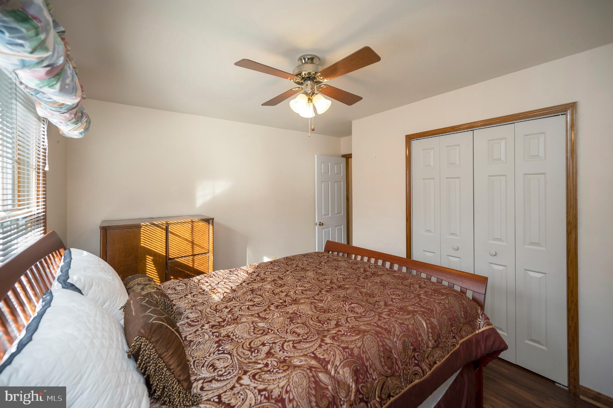 117 Green Street Locust Grove, VA 22508 - Photo 42 of 63 a bedroom with a bed and a chandelier