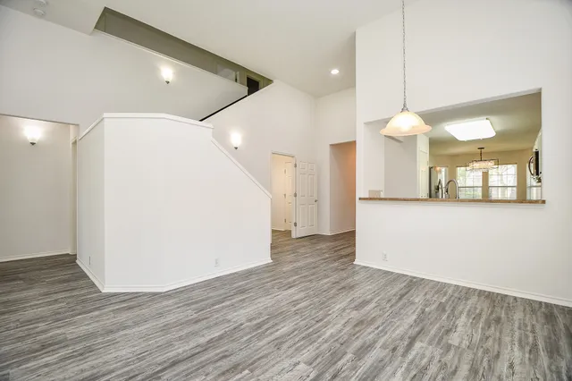 a view of a kitchen with wooden floor and a sink