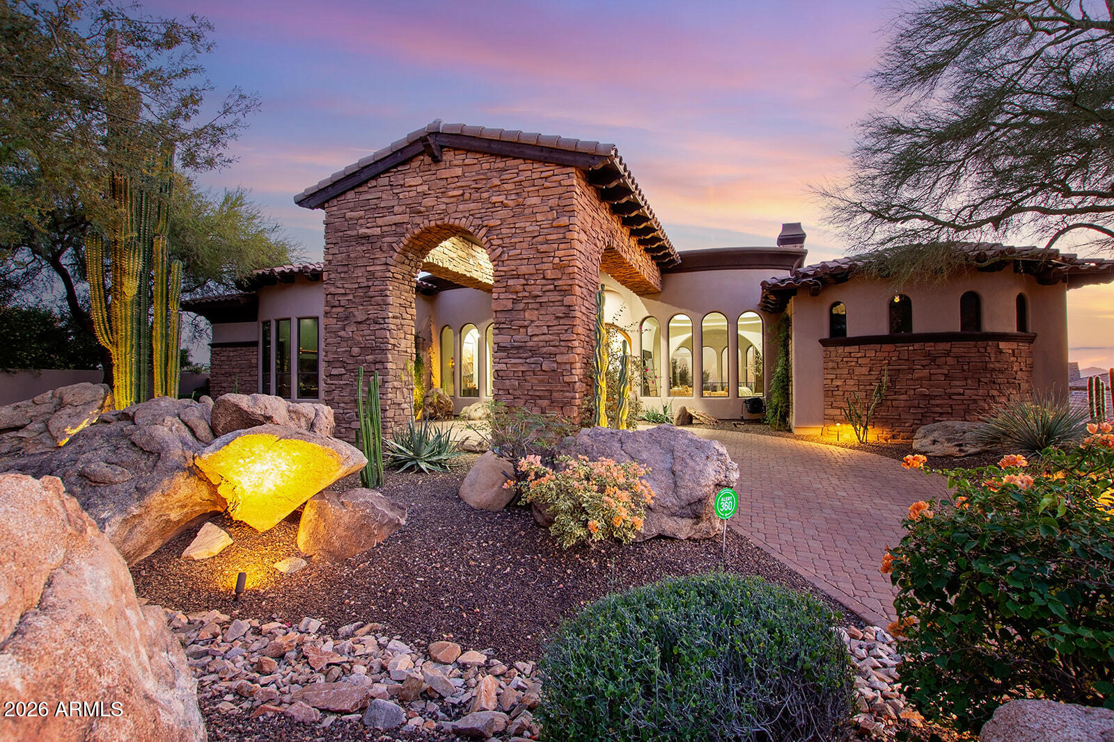 a front view of a house with a yard and outdoor seating
