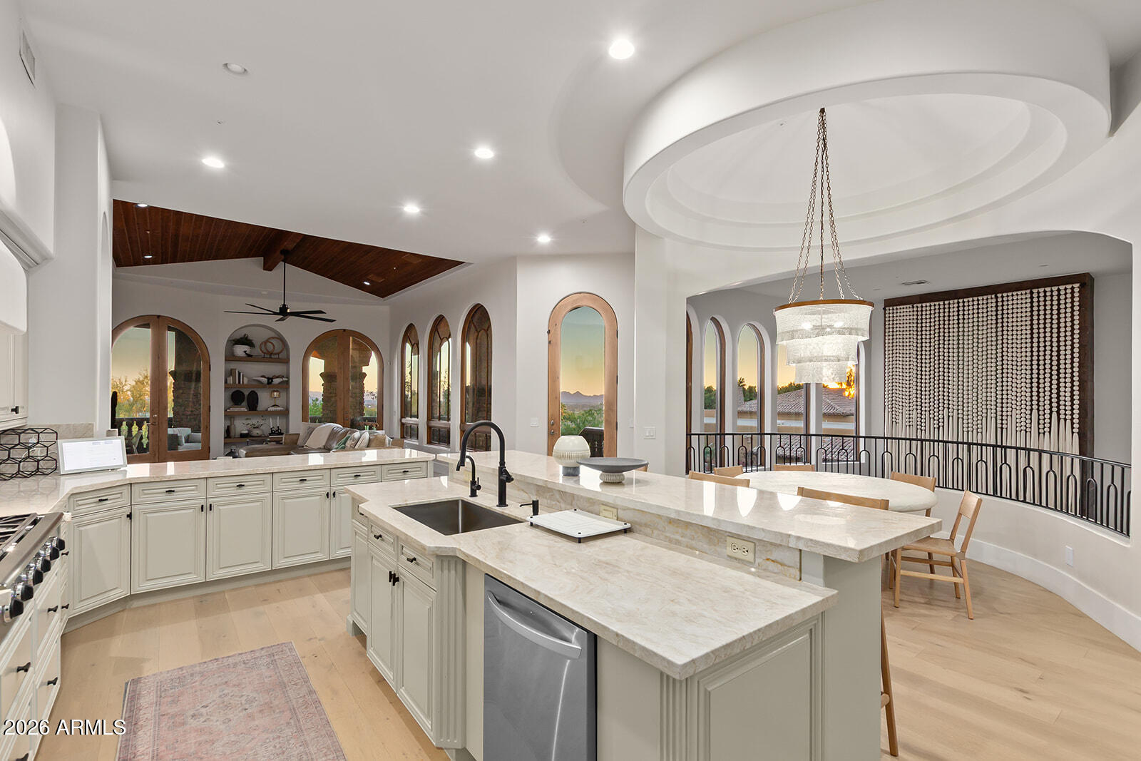 11861 East Desert Trail Road Scottsdale, AZ 85259 - Photo 11 of 63 a kitchen with a stove a sink a dining table and chairs