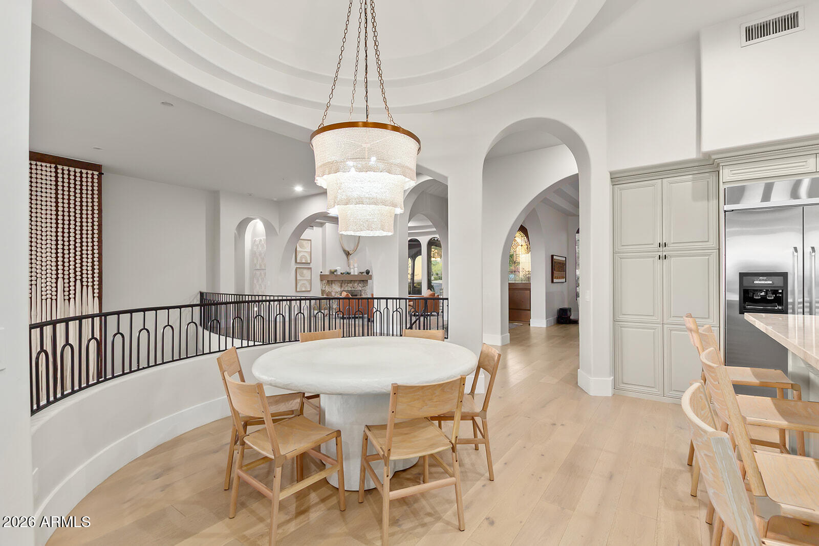11861 East Desert Trail Road Scottsdale, AZ 85259 - Photo 13 of 63 a view of a dining room with furniture a chandelier and wooden floor