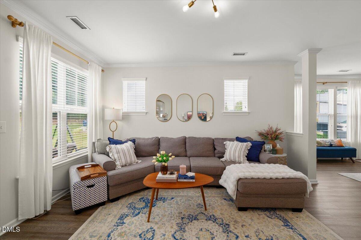8449 Central Drive Raleigh, NC 27613 - Photo 12 of 38 a living room with furniture a rug and a large window