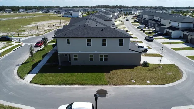 an aerial view of a house with outdoor space and lake view
