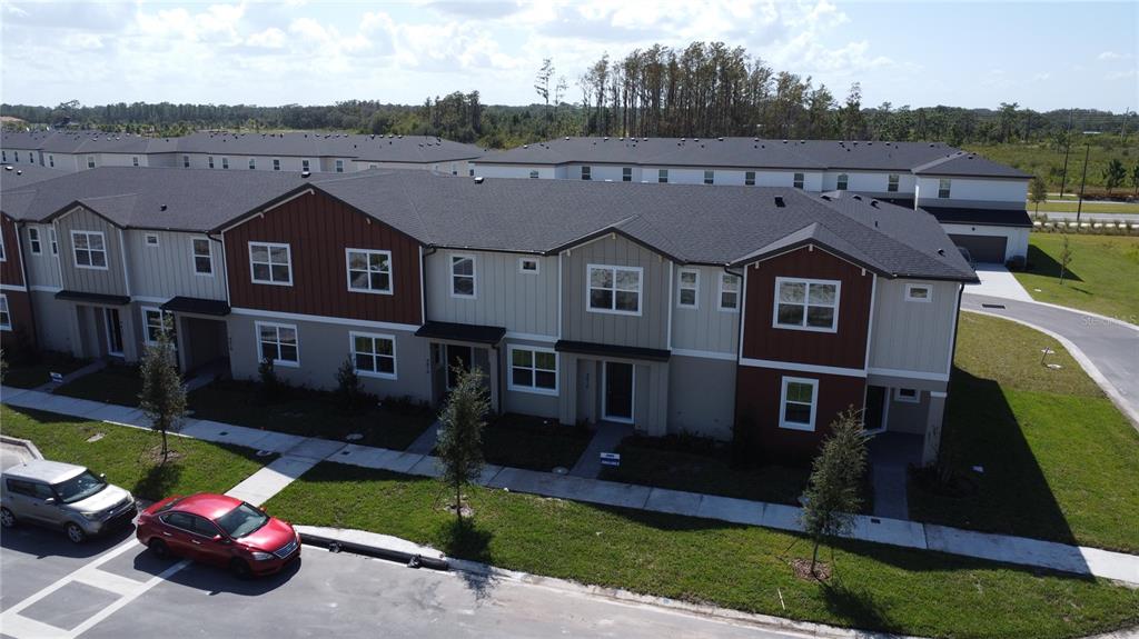 4806 Prairie Preserve Run St. Cloud, FL 34772 - Photo 8 of 21 an aerial view of a house with a garden and yard