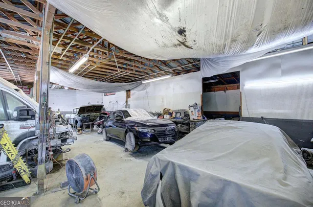 a living room with furniture a flat screen tv and a window