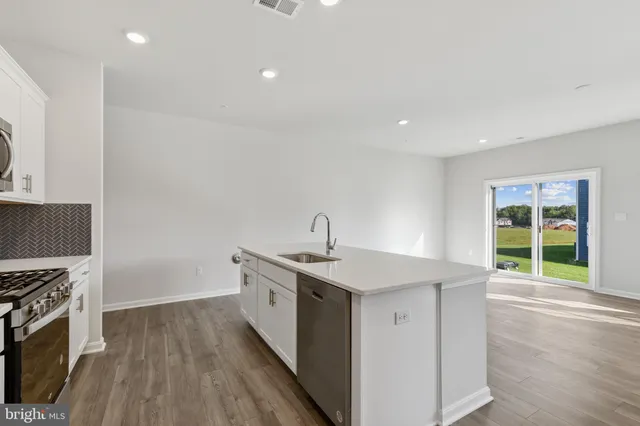 a kitchen with a sink stove and cabinets