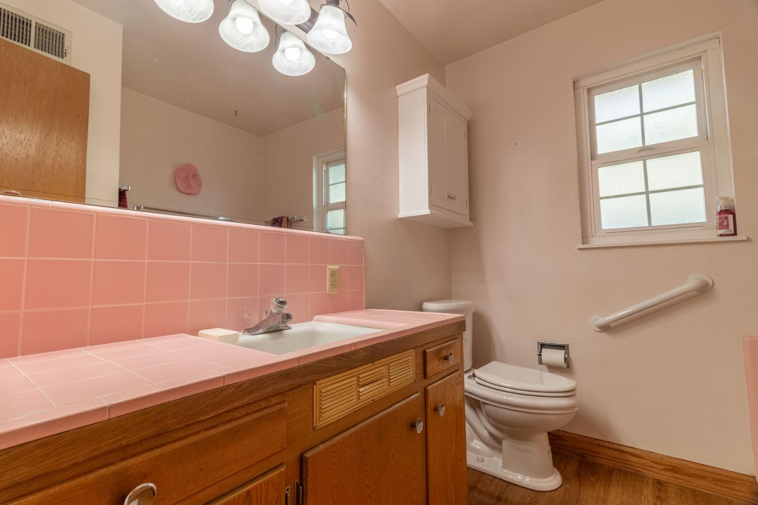822 South California Street Lodi, CA 95240 - Photo 23 of 34 a bathroom with a sink a toilet and a mirror