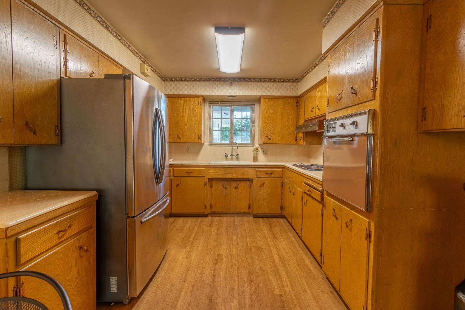822 South California Street Lodi, CA 95240 - Photo 10 of 34 a kitchen with stainless steel appliances a refrigerator a sink and white cabinets