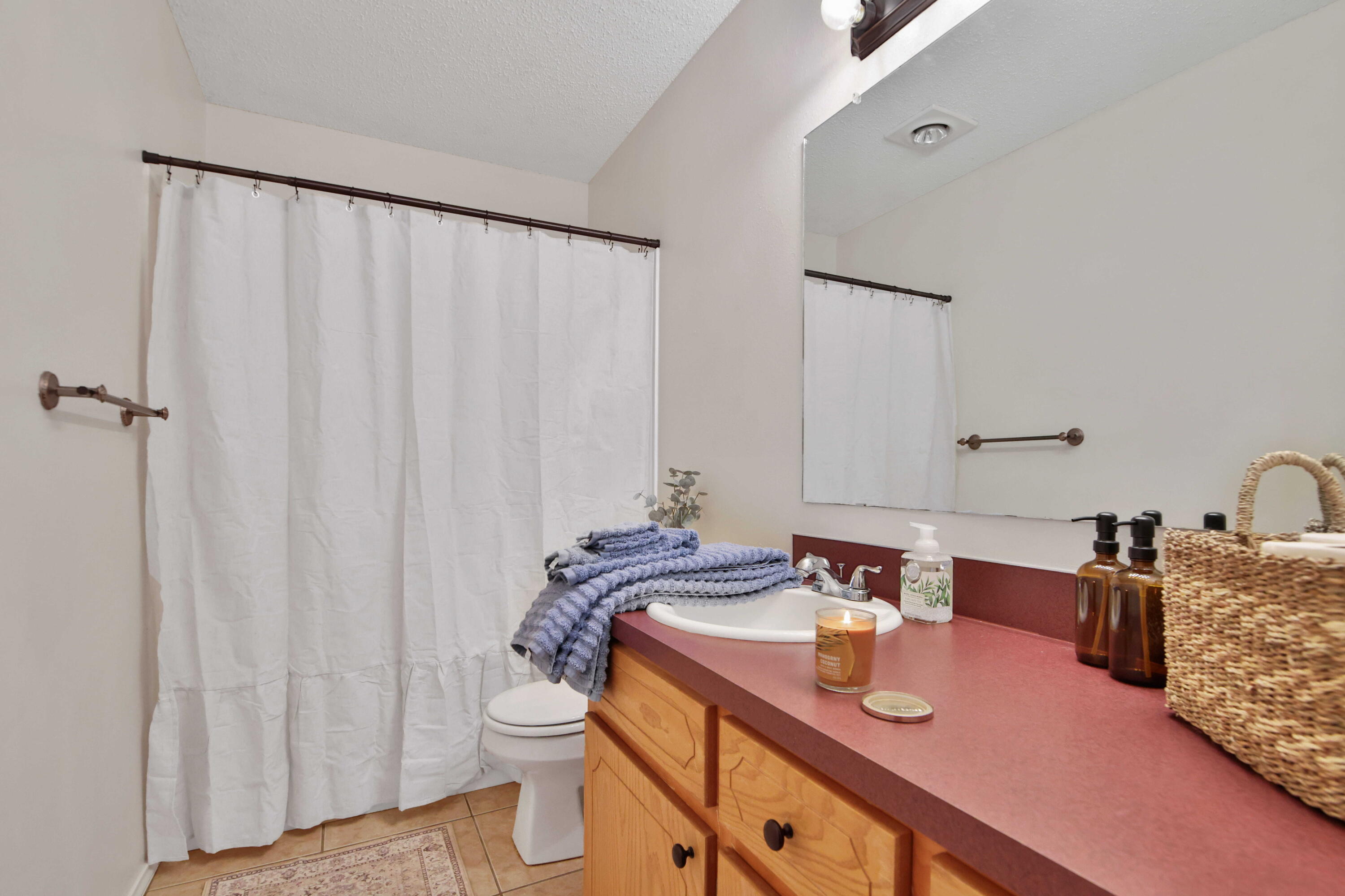 2907 90th Street Lubbock, TX 79423 - Photo 11 of 30 a bathroom with a granite countertop sink and a mirror