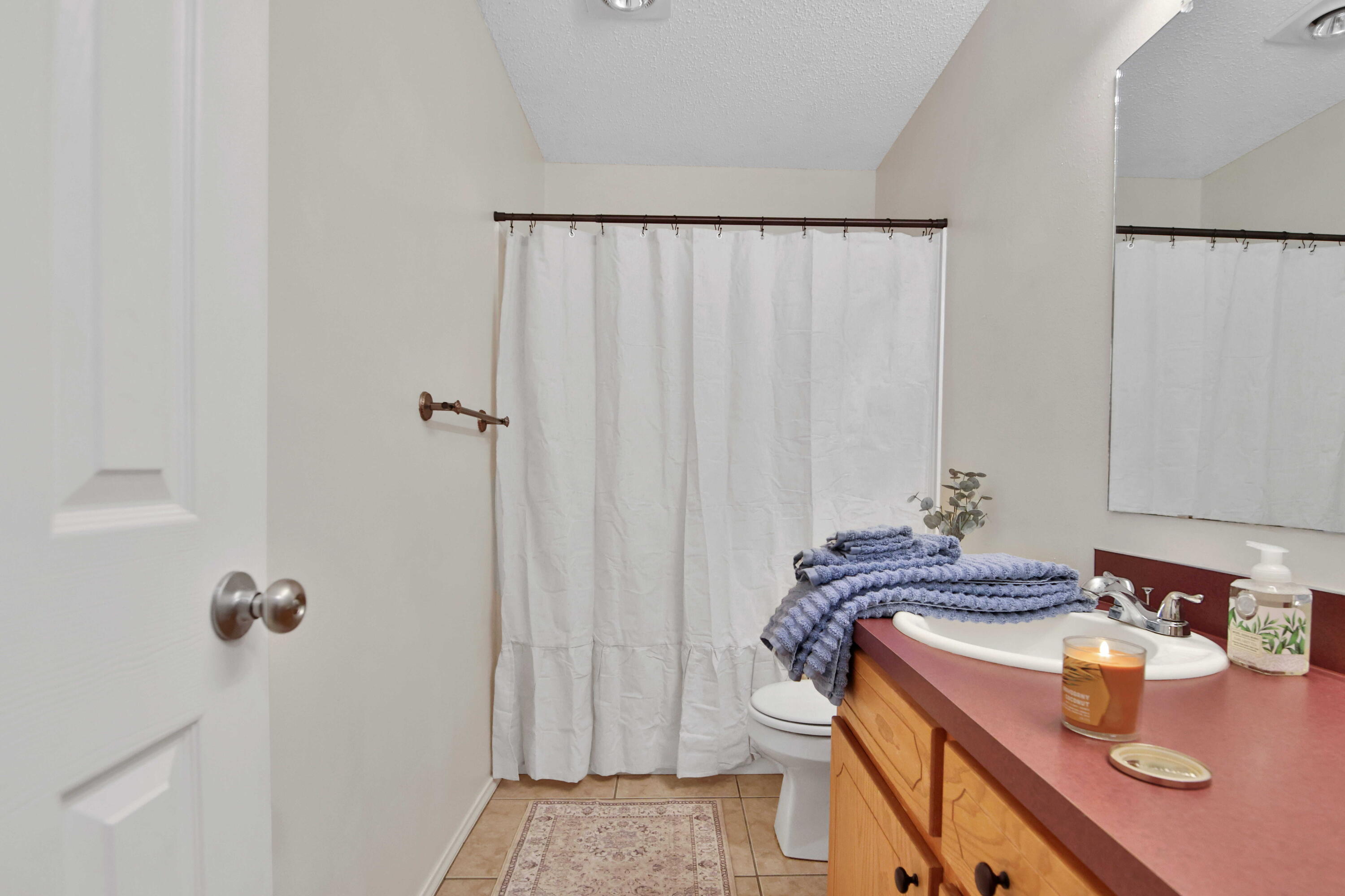 2907 90th Street Lubbock, TX 79423 - Photo 12 of 30 a bathroom with a sink and a mirror