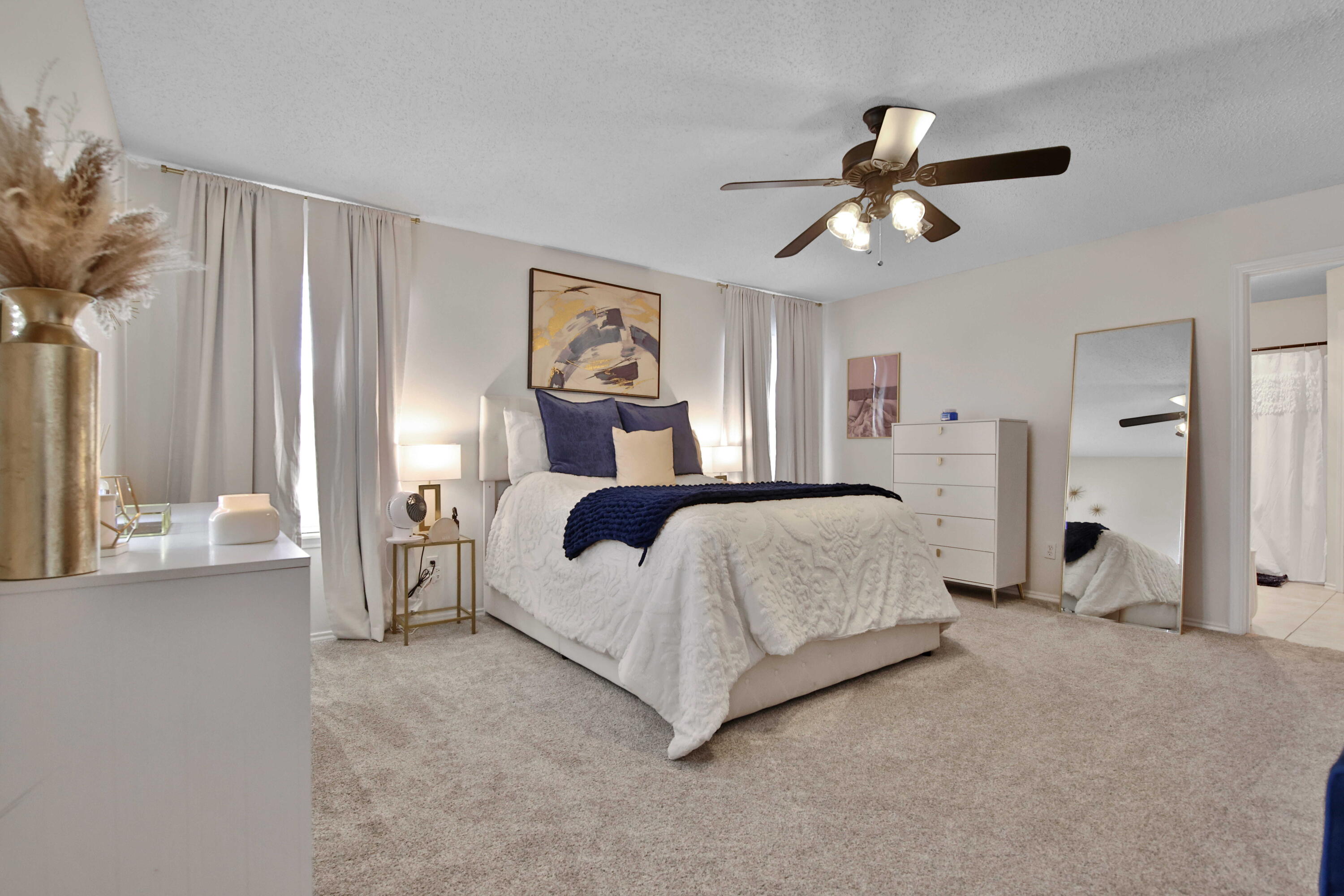 2907 90th Street Lubbock, TX 79423 - Photo 13 of 30 a bedroom with a bed and a chandelier