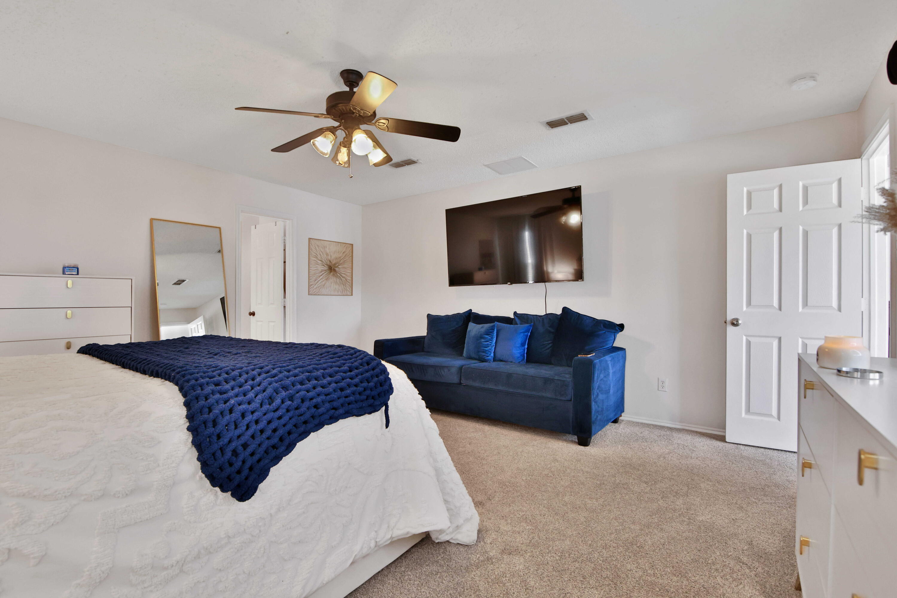 2907 90th Street Lubbock, TX 79423 - Photo 14 of 30 a bedroom with a large bed and a flat screen tv