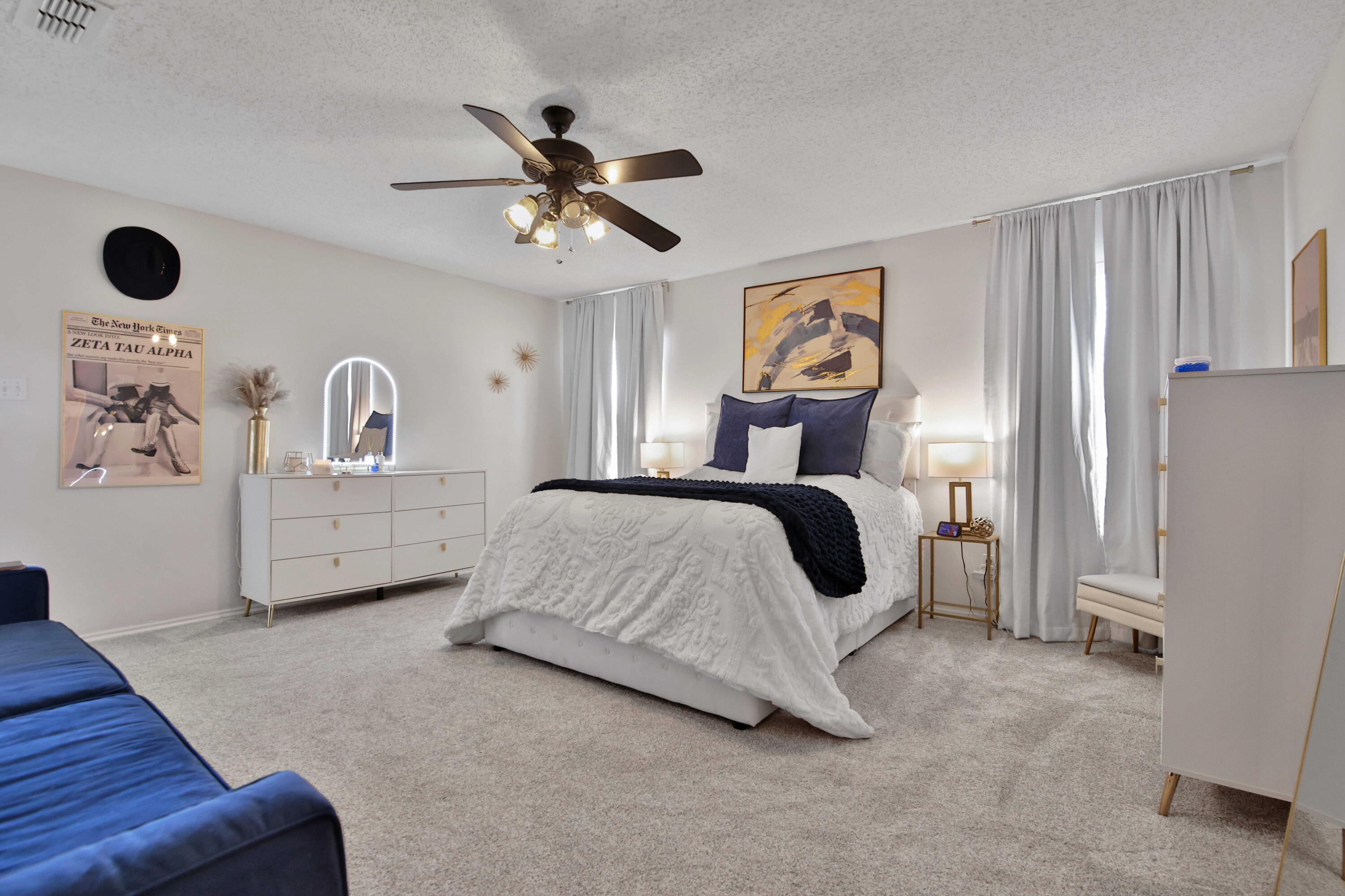 2907 90th Street Lubbock, TX 79423 - Photo 15 of 30 a spacious bedroom with a bed and a chandelier