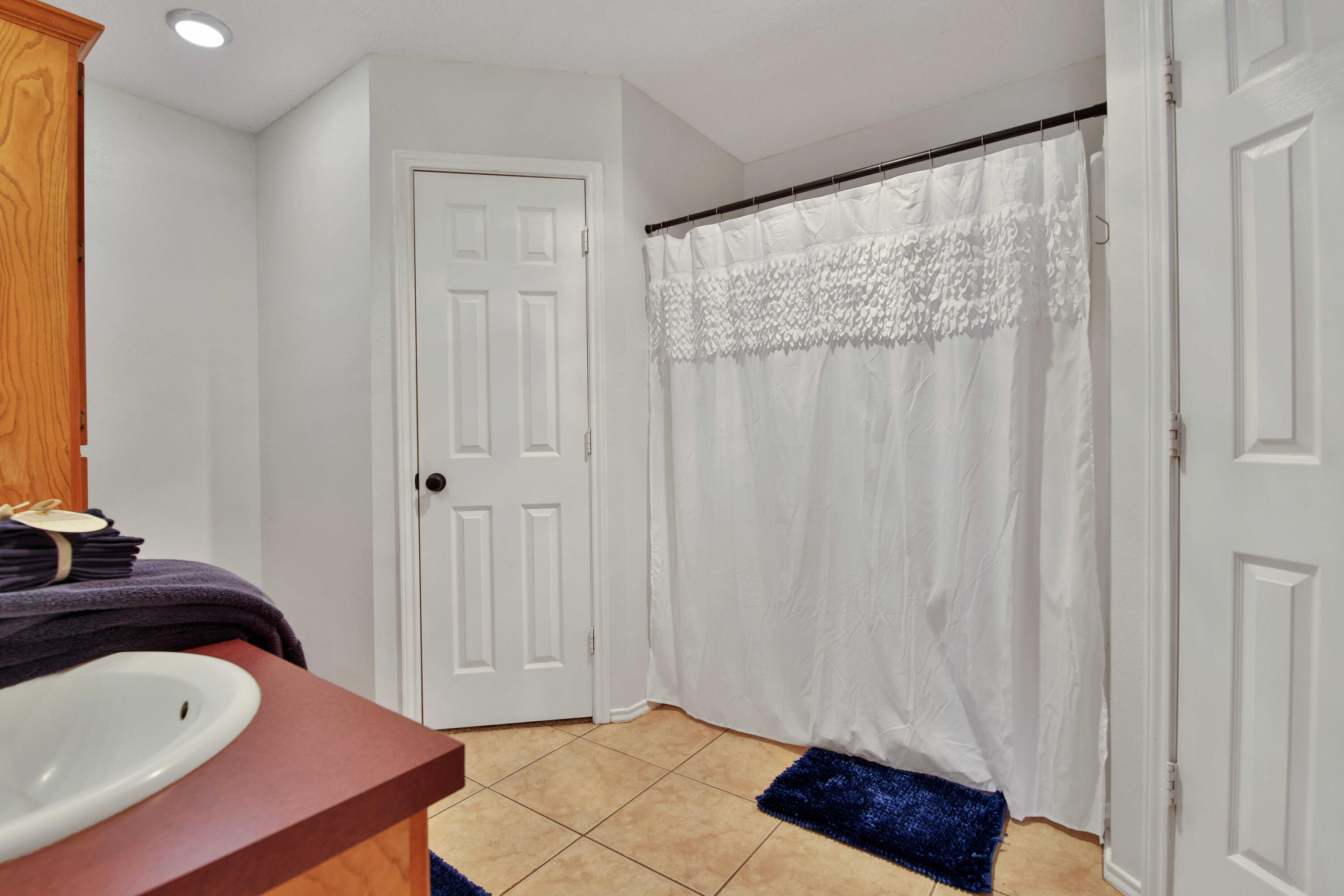 2907 90th Street Lubbock, TX 79423 - Photo 16 of 30 a bedroom with a bed and a mirror