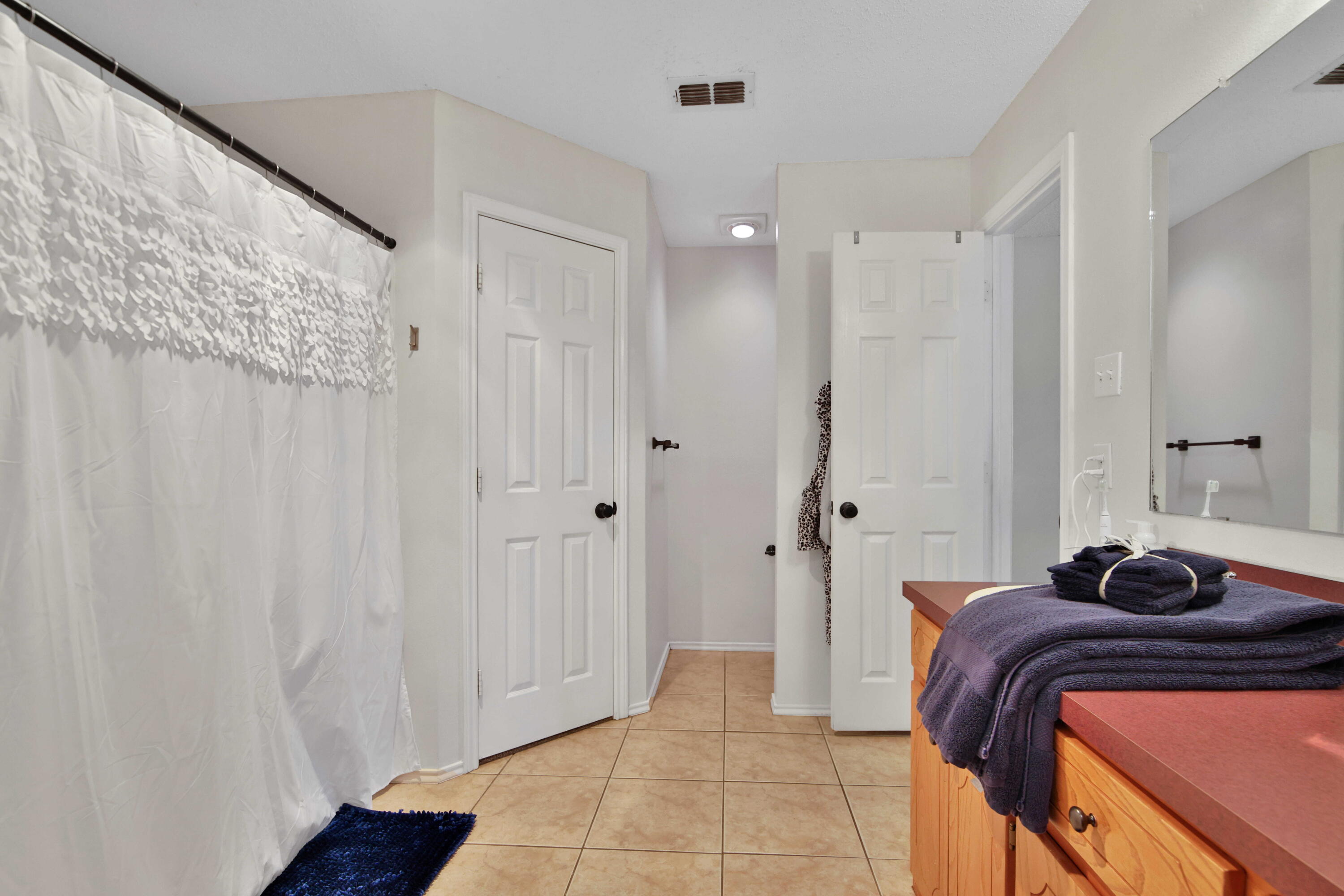 2907 90th Street Lubbock, TX 79423 - Photo 18 of 30 a bedroom with a bed and a shower