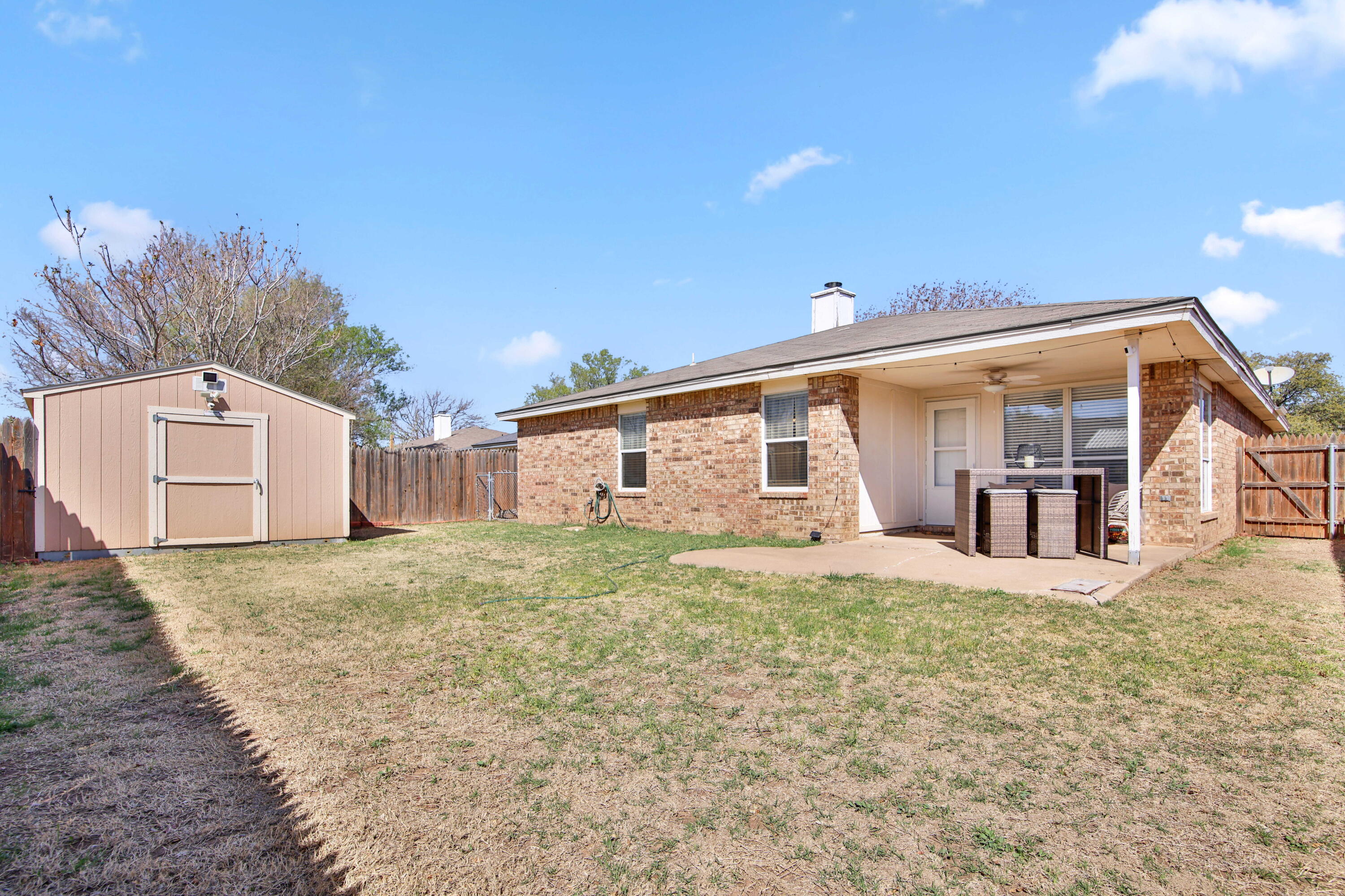 2907 90th Street Lubbock, TX 79423 - Photo 30 of 30 a view of a yard in front of a house with a large tree