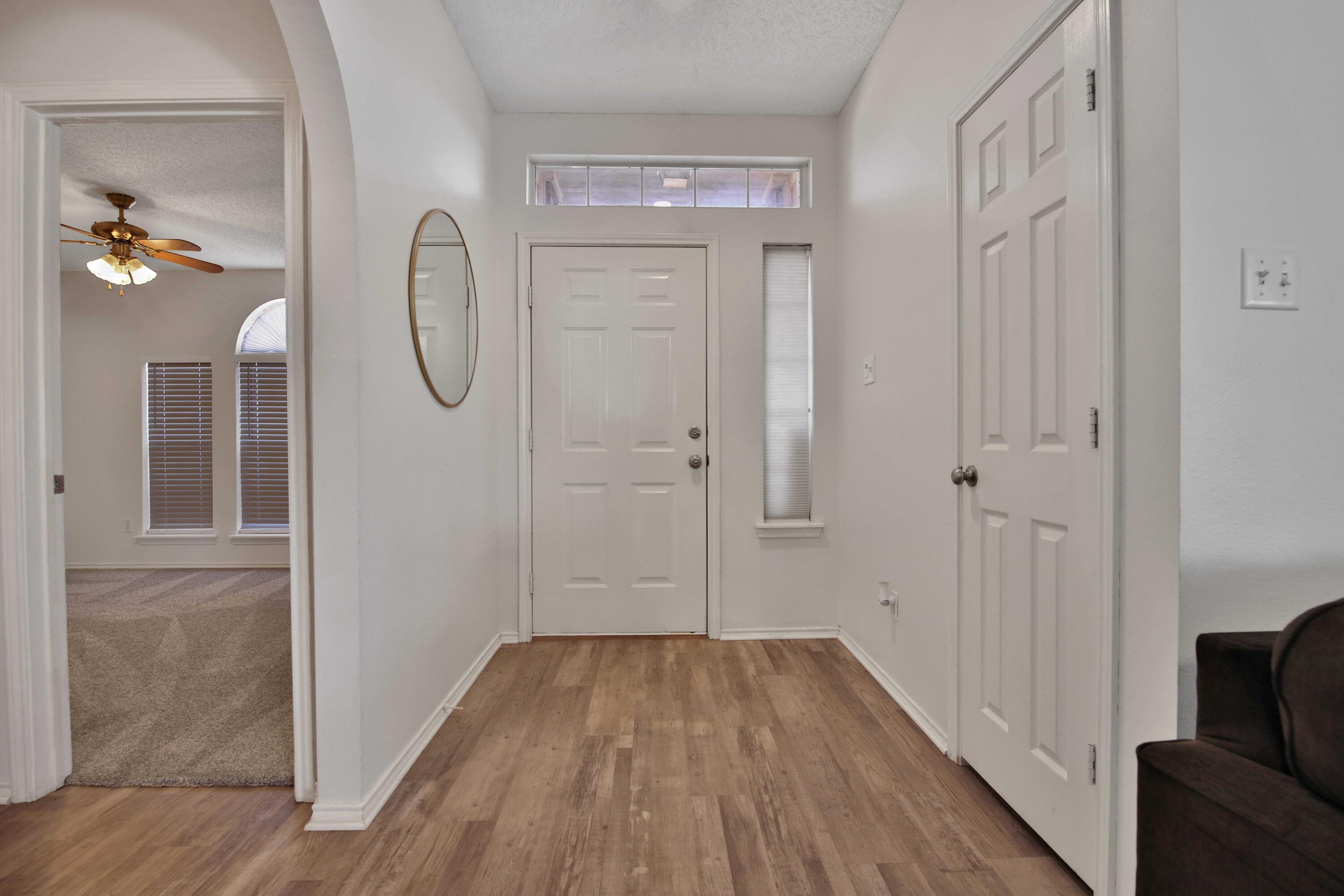 2907 90th Street Lubbock, TX 79423 - Photo 5 of 30 a view of a livingroom with wooden floor and a bathroom
