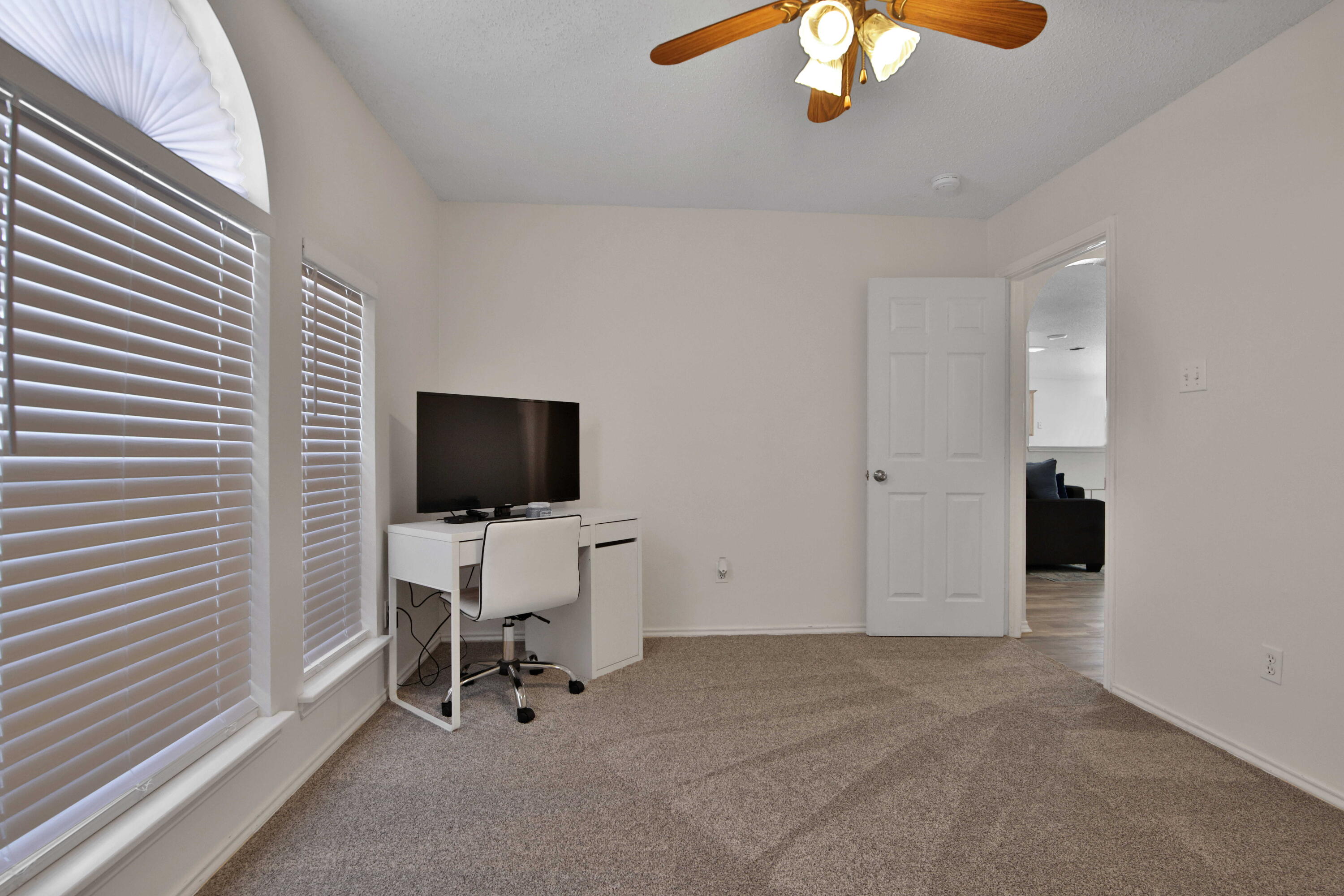 2907 90th Street Lubbock, TX 79423 - Photo 8 of 30 a view of a livingroom with a chair and a chandelier