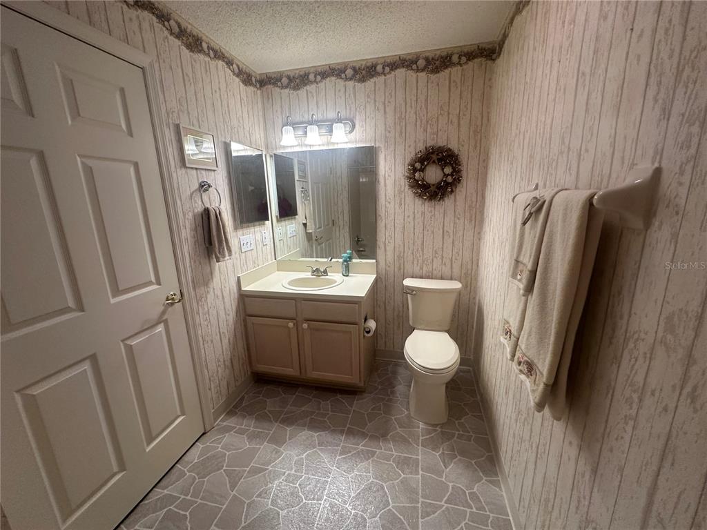 9258 Southwest 91st Circle Ocala, FL 34481 - Photo 13 of 25 a bathroom with a granite countertop sink toilet and shower