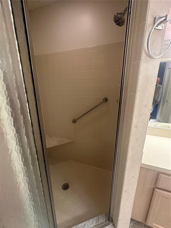 9258 Southwest 91st Circle Ocala, FL 34481 - Photo 19 of 25 a bathroom with a glass door shower and vanity