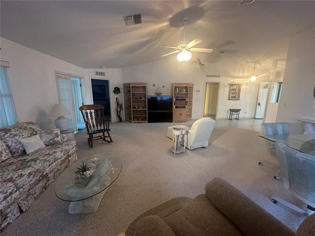 9258 Southwest 91st Circle Ocala, FL 34481 - Photo 7 of 25 a living room with furniture and a gym machine
