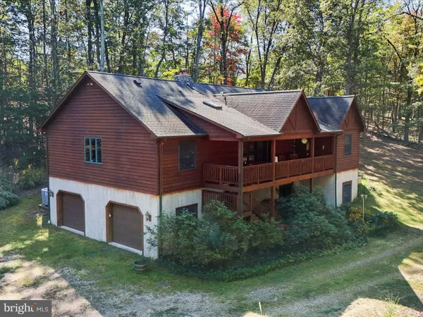 a aerial view of a house with a yard table and chairs