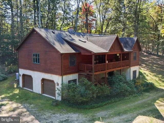 a aerial view of a house with a yard table and chairs