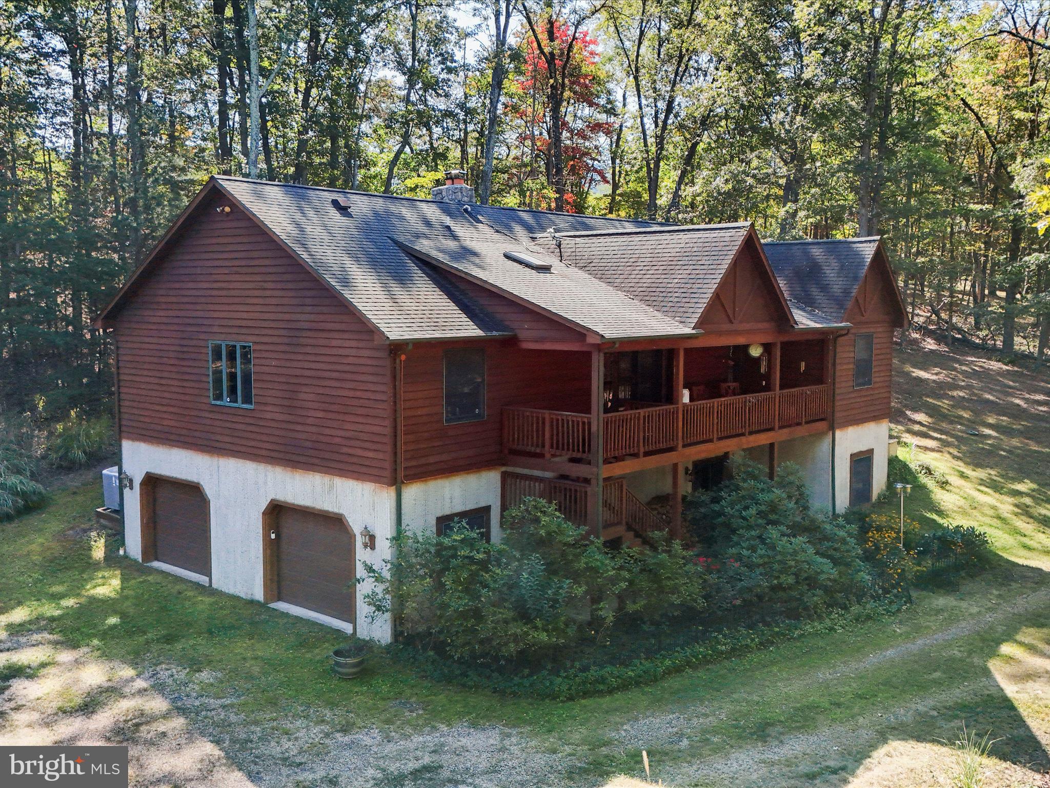 a aerial view of a house with a yard table and chairs