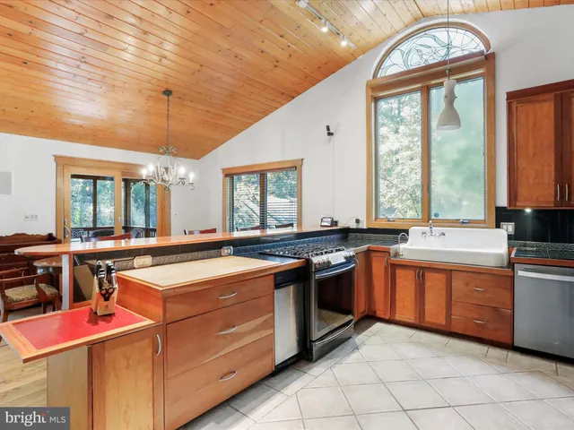 a kitchen with stainless steel appliances granite countertop a stove and a sink