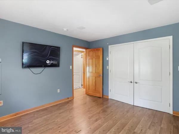 a view of a patio with a dining table and chairs with wooden floor