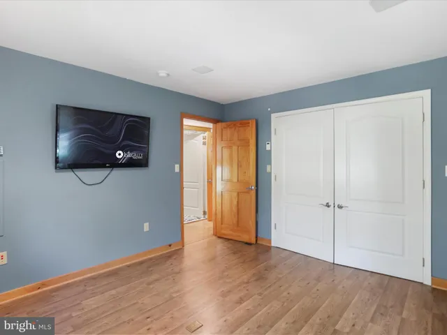 a view of a patio with a dining table and chairs with wooden floor